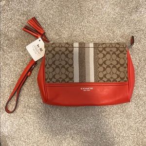 Orange/tan coach wristlet